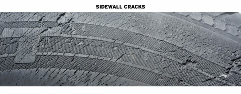 closeup of cracks in the sidewall of a tire