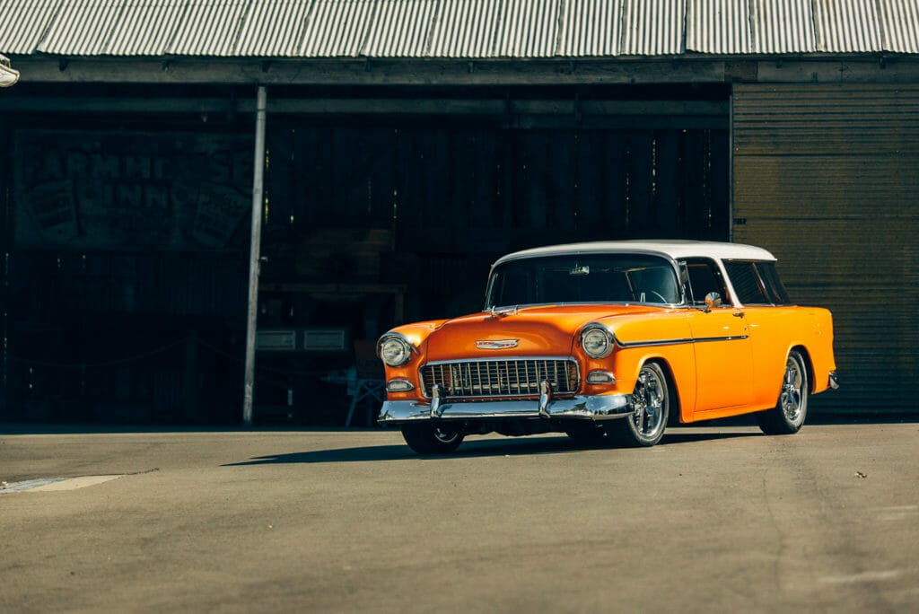Front three-quarter shot of Brian Hill of Hill’s Rod and Custom Orange Modified 1955 Chevy Nomad