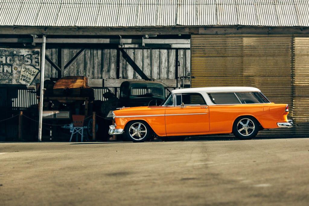 Profile shot of Brian Hill of Hill’s Rod and Custom Orange Modified 1955 Chevy Nomad