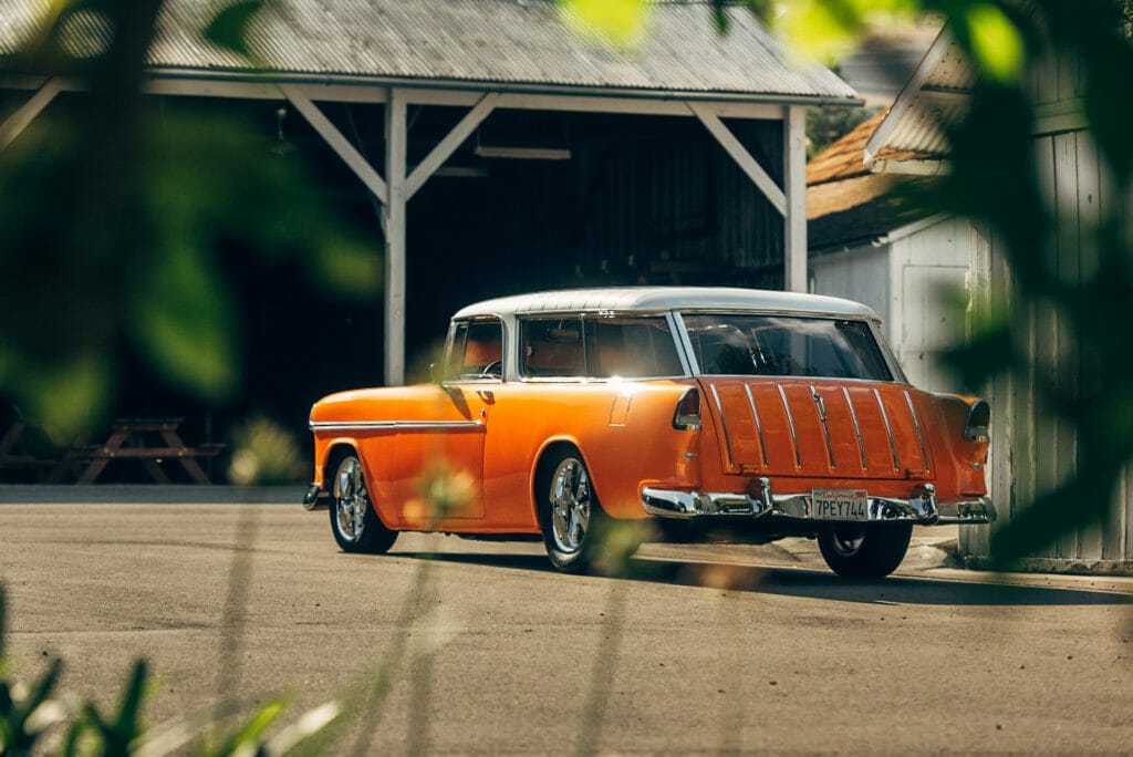 rear 3/4 view of Brian Hill of Hill’s Rod and Custom Orange Modified 1955 Chevy Nomad