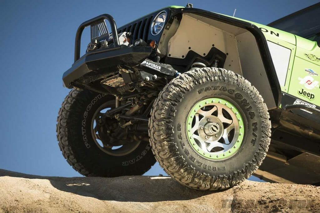 green jeep LJ with off road patagonia MT mud terrain tires