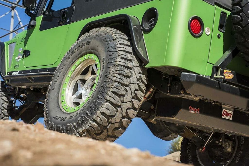 green jeep LJ with off road patagonia MT mud terrain tires