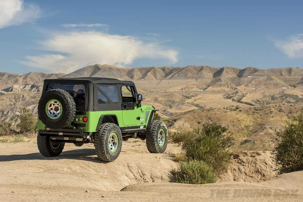 green jeep LJ with off road patagonia MT mud terrain tires