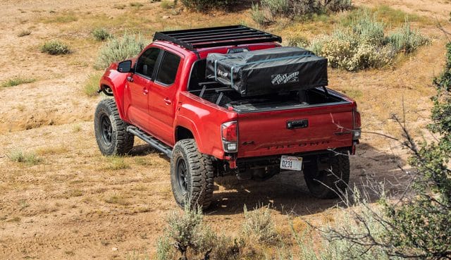 Red overland toyota tacoma with Patagonia MT offroad tires