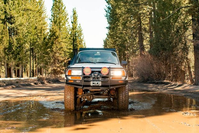 Toyota Land Cruiser rolling through mud with Milestar Patagonia MT Offroad Tires