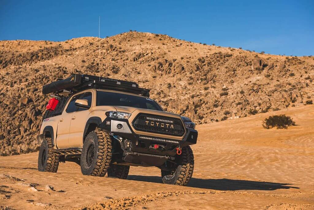 Toyota Tacoma with 35 inch Milestar Patagonia MT tires driving through a sandy desert