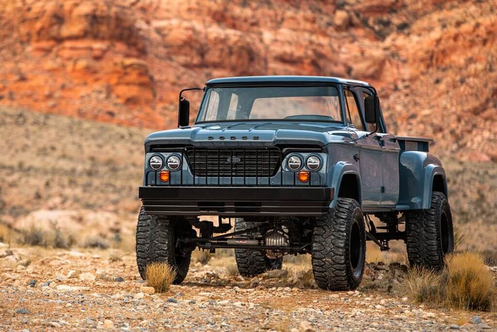 Blue 1968 Dodge W300 with Milestar Patagonia M/T tires on some rocks