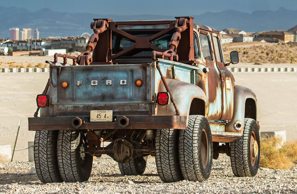 rear of hodson motors custom ford f600 dually in desert on patagonia tires