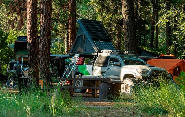 gray toyota tacoma overlander set up to camp 