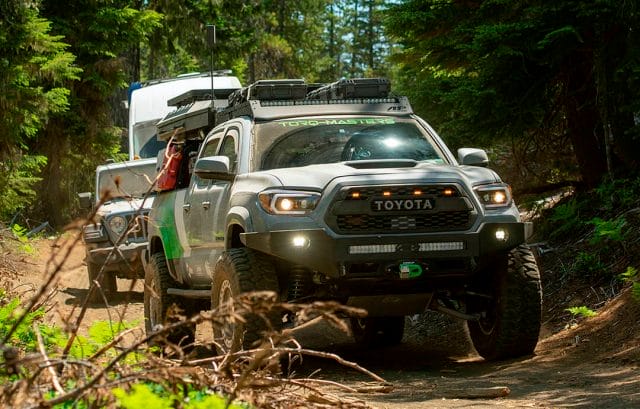 Torq-Masters Gray Toyota Tacoma followed by a jeep in a forest trail